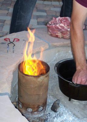starting the dutch oven in a firepit and a chimney to start the briquets in