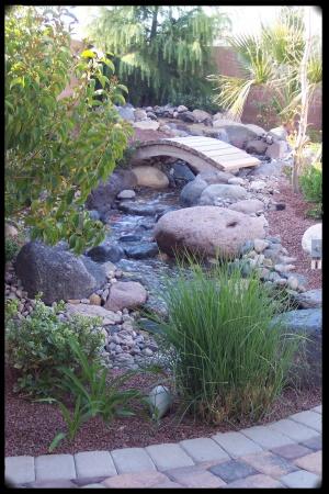 cascading brookwith bridge over it